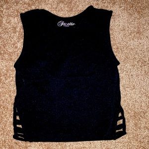 Small, black and cropped workout tank top with slits on the bottom corners